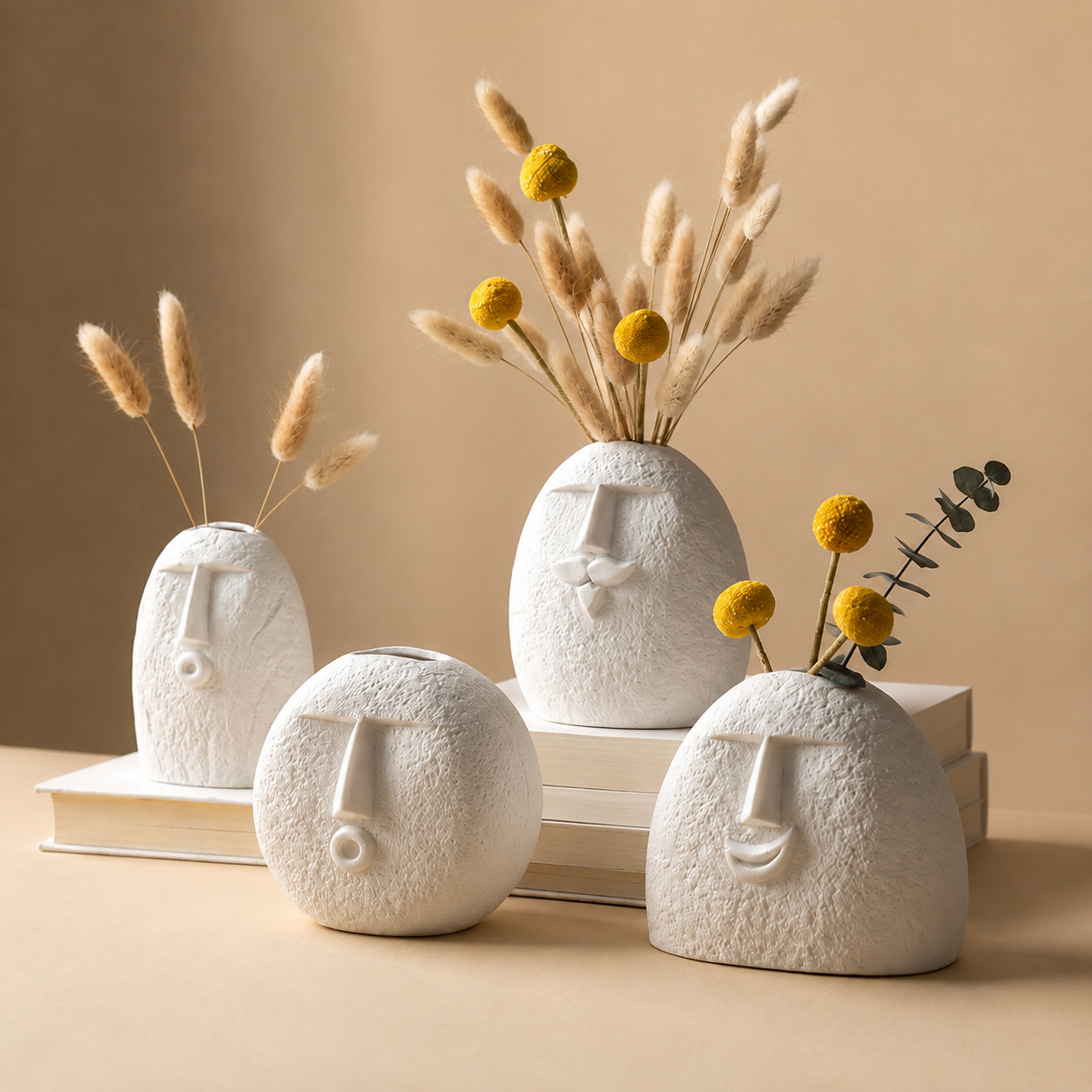 Abstract face vases with pampas grass and yellow flowers