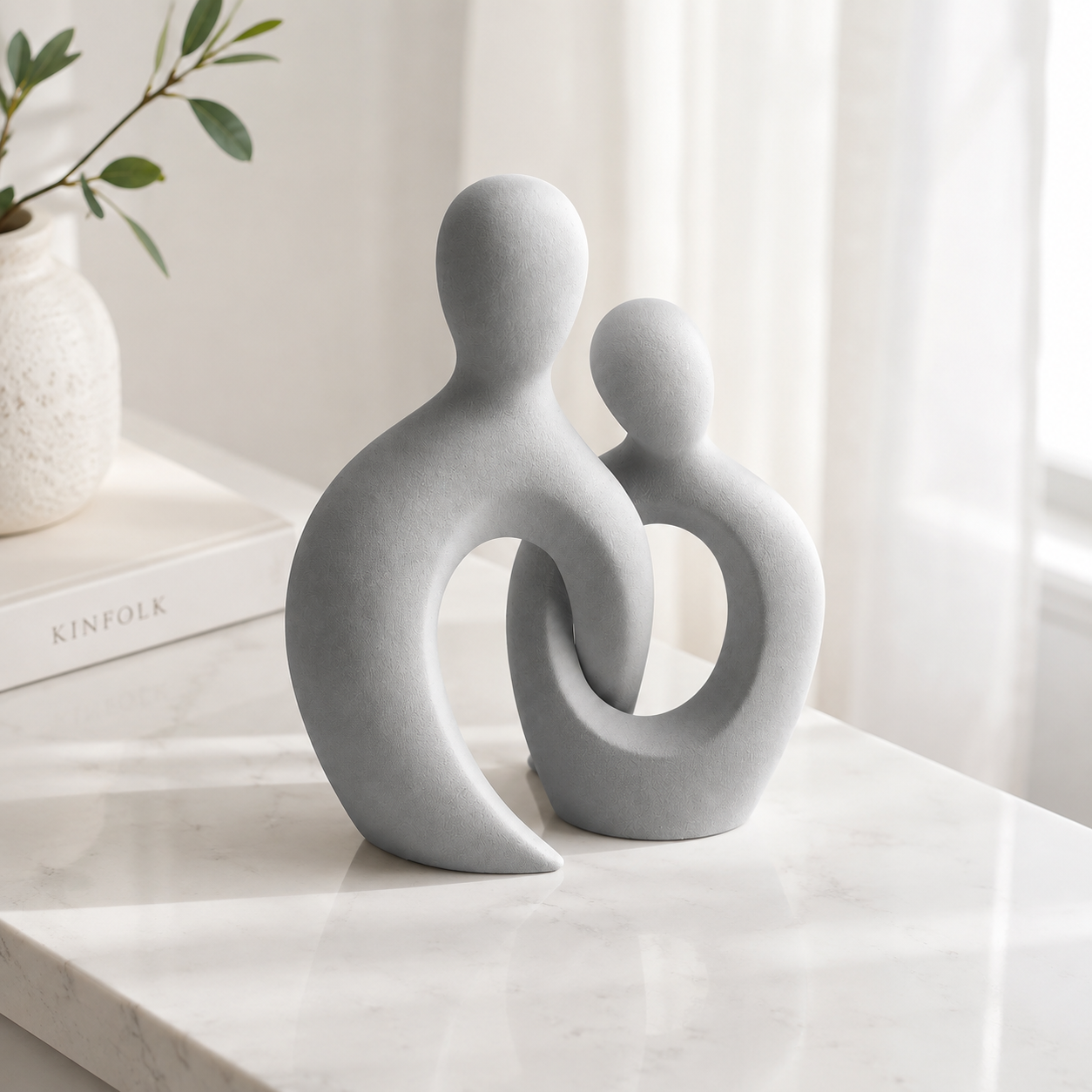 Abstract couple sculpture on shelf with arch