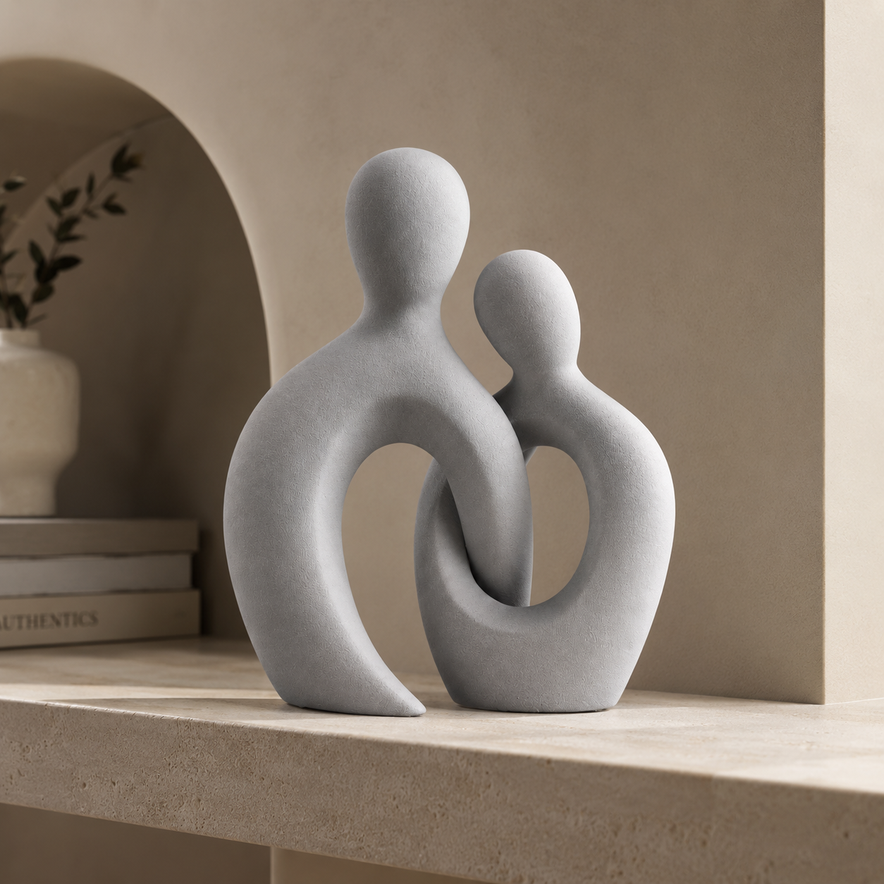 Abstract couple sculpture on wooden dresser